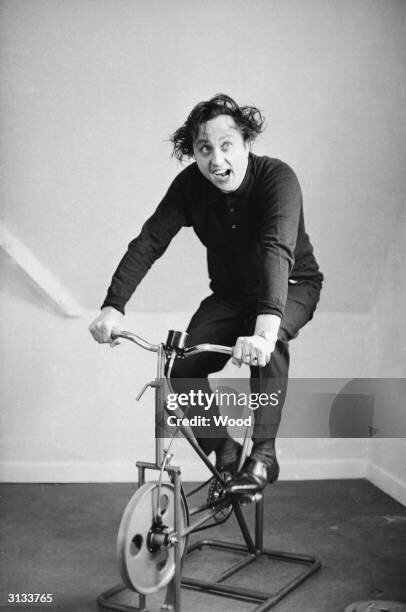 english-comedian-ken-dodd-on-an-exercise-bike-725502898.jpg