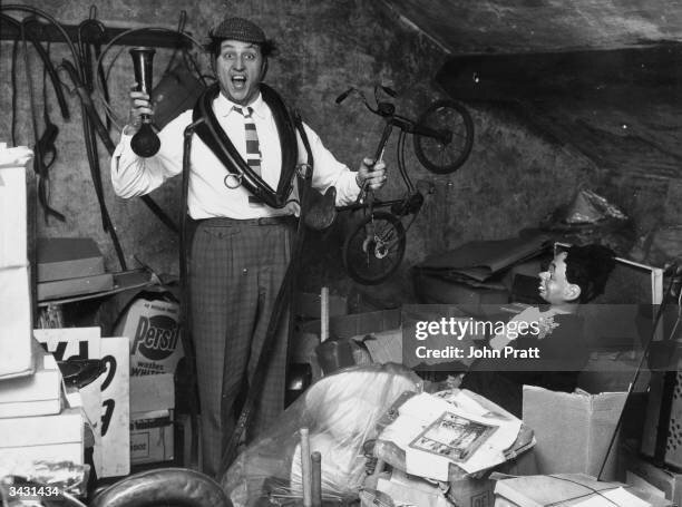 liverpudlian-comedian-ken-dodd-sorts-through-a-heap-of-junk-including-a-ventriloquists-dummy-a...jpg