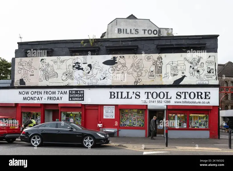 bills-tool-store-and-bud-neill-lobey-dosser-mural-bain-street-the-barras-glasgow-scotland-uk-...webp